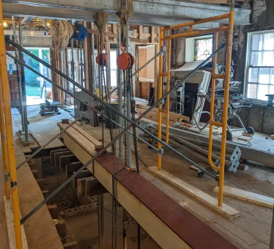 Interior steel beam installation with temporary shoring during structural renovation